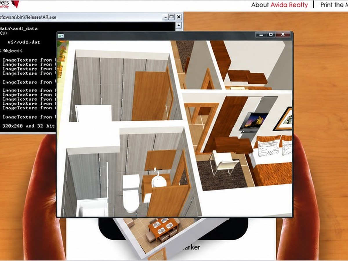 A 3D apartment plan rendered over a printed marker held up to a webcam.