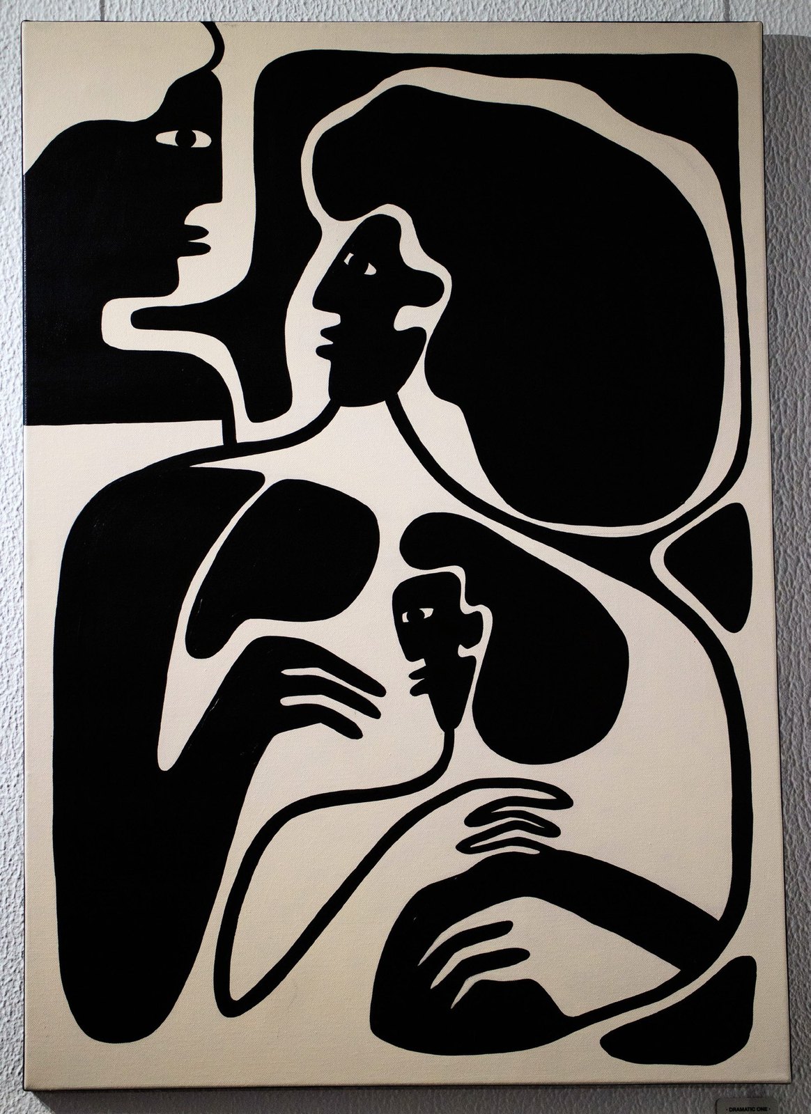 Drama: two black figures, one holding the other.