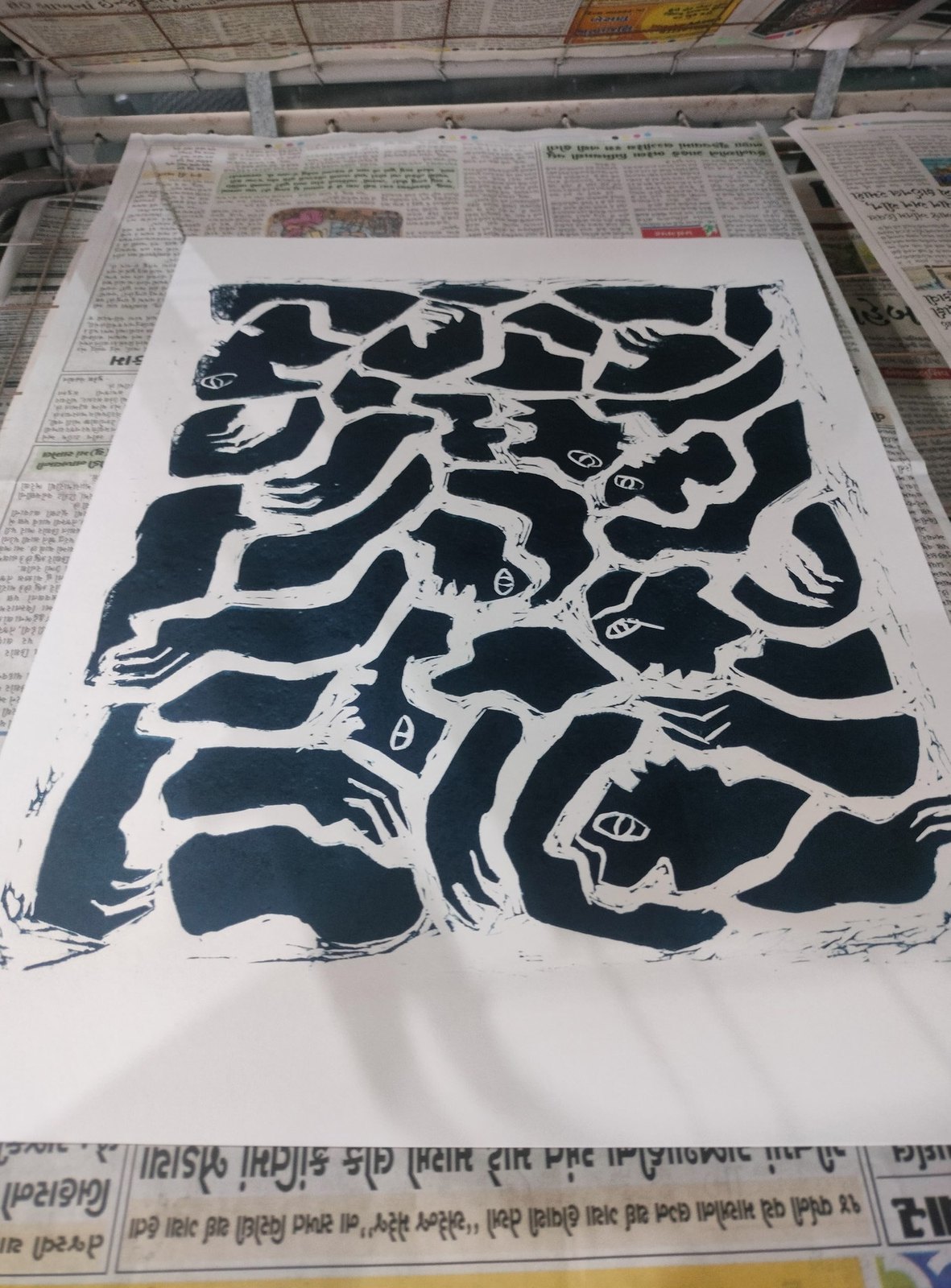 A linocut print laid out on the studio floor.