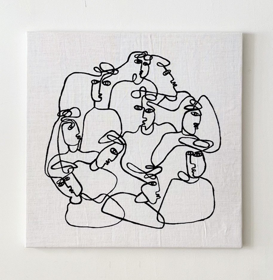 An embroidered square of line figures.