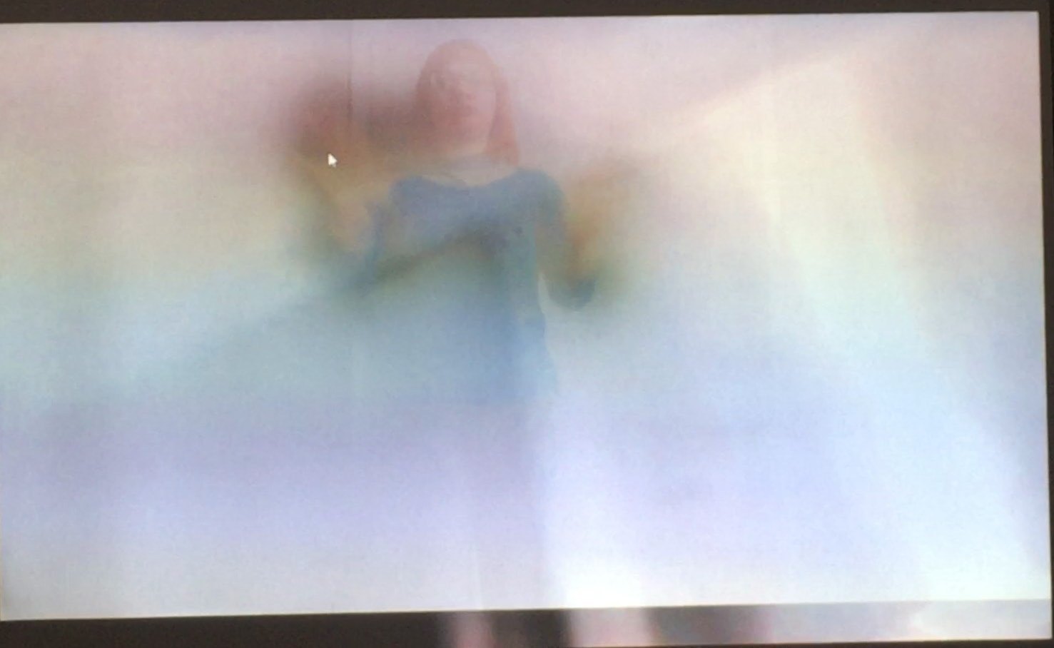 The projection: a figure half visible through the fog.