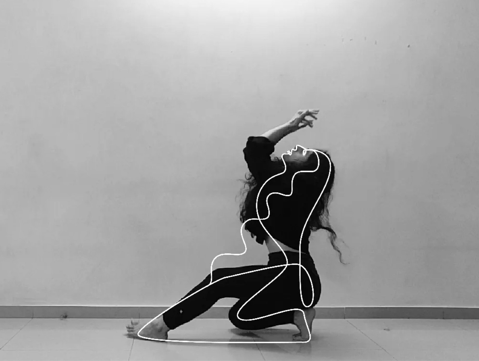 A dancer on the floor with a white line drawn over her body.