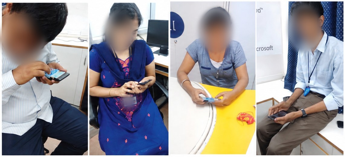 Four participants at L.V. Prasad Eye Institute trying the braille pad on phones.