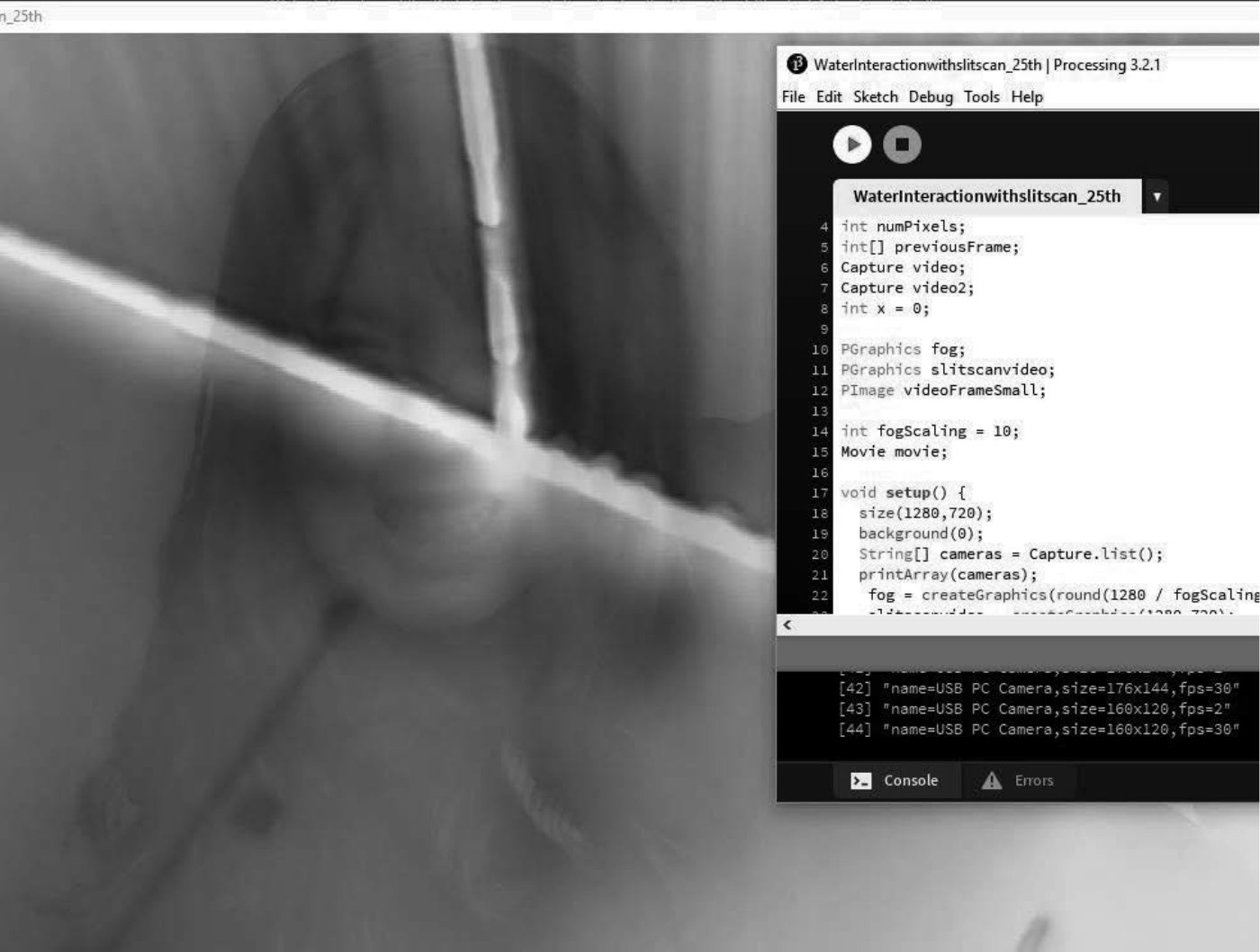 A floating camera view of the room, tilted and blurred, beside the Processing code.