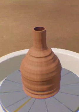 A clay pot on the wheel before firing.