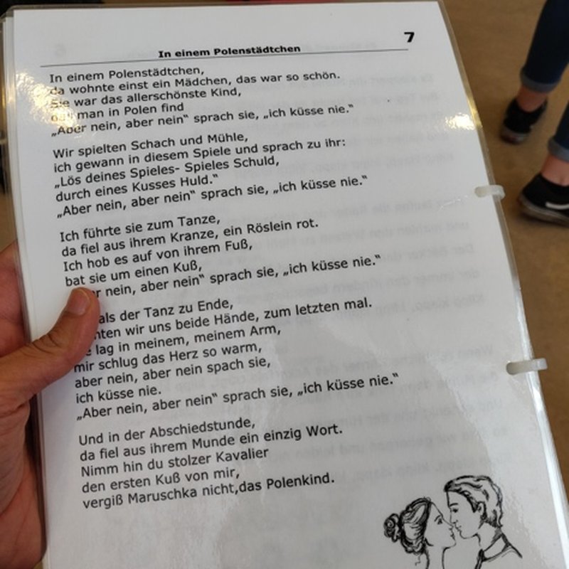 A printed newspaper page held open during the morning reading session.