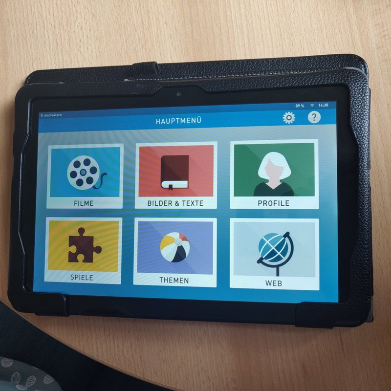 A tablet showing a simple picture menu of activities.